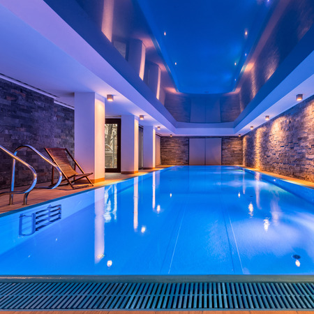 Luxurious villa swimming pool with brick walls, evening viewの写真素材