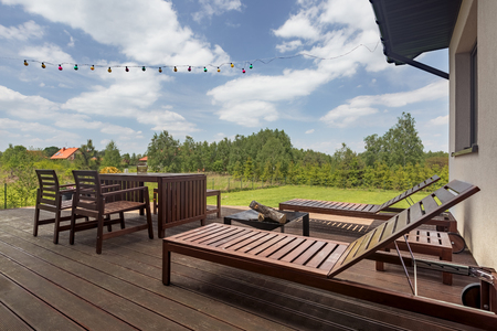 Modern villa patio with wooden decking and outdoor furniture setの写真素材