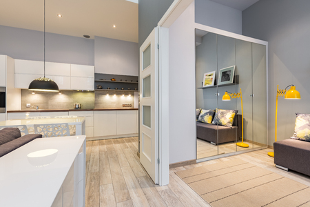New design apartment with functional kitchen and white sliding doorの写真素材