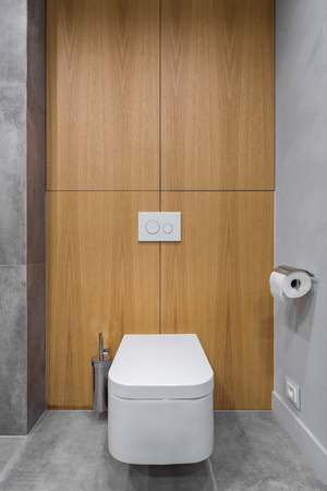 Gray bathroom with toilet and decorative wooden wallの写真素材