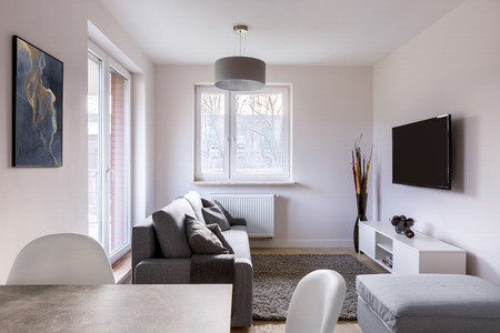 Small living room with table, couch and televisionの写真素材