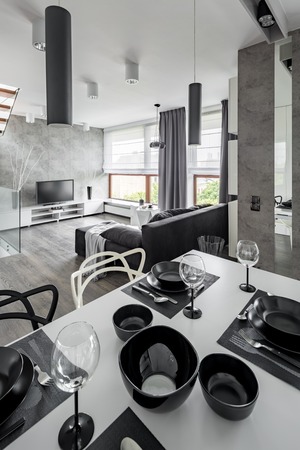 Home interior with white table with modern tablewareの写真素材
