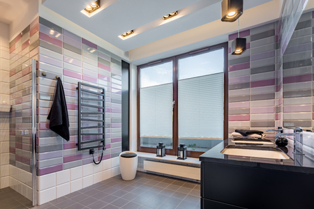 Spacious bathroom with big window and two basinsの写真素材