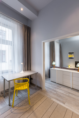 Home office interior with yellow chair and simple deskの写真素材