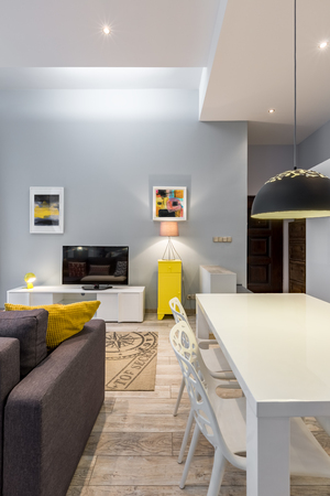 Home interior with modern white table and openwork chairsの写真素材