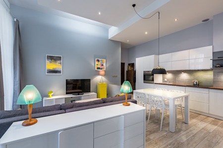 Modern home interior with two small lamps standing on a white dresserの写真素材