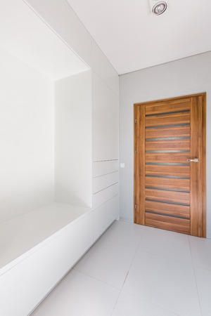Home interior with wooden internal door and white wallsの写真素材
