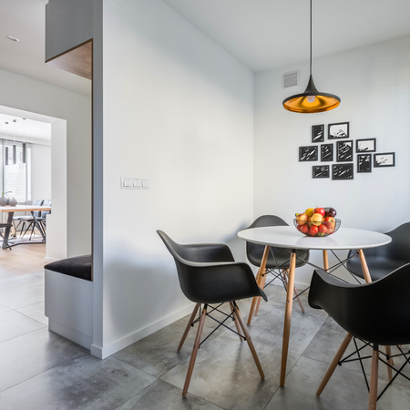Modern home interior with round table and black chairsの写真素材