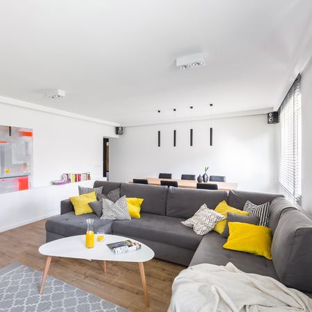 Modern, white living room with extra large gray sofa and stylish tableの写真素材