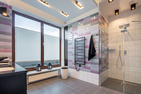 Modern bathroom with walk in shower, ceiling lighting and big windowの写真素材