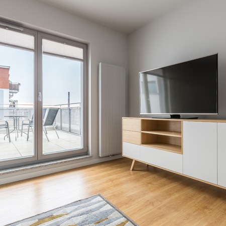 Modern room with big tv and exit to the terraceの写真素材