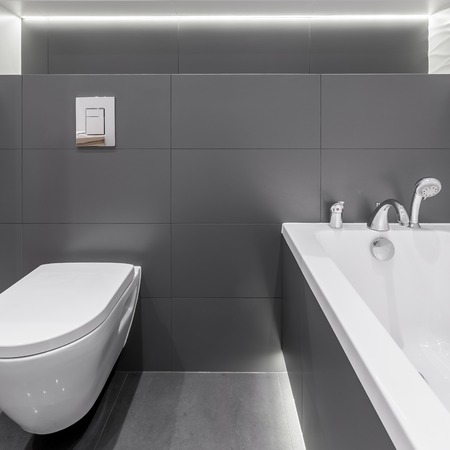 Bathtub and toilet seat in modern graphite bathroomの写真素材