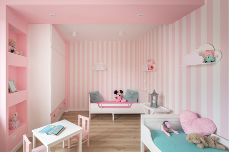 Pink baby room with striped wall and white furnitureの写真素材