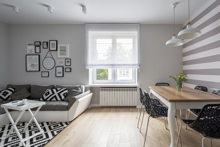 Modern apartment with gray sofa and wooden tableの写真素材