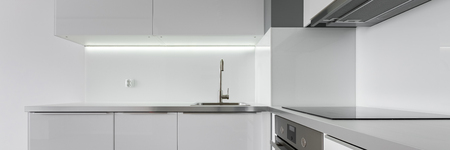 Panoramic view of modern kitchen with white furnitureの写真素材