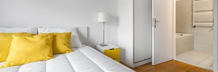 Modern, white bedroom with closet and private bathroom, panoramaの写真素材