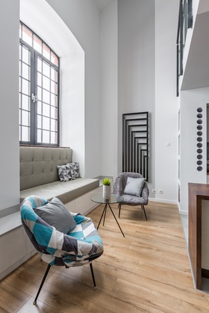 Modern apartment with window seat and round chairの写真素材