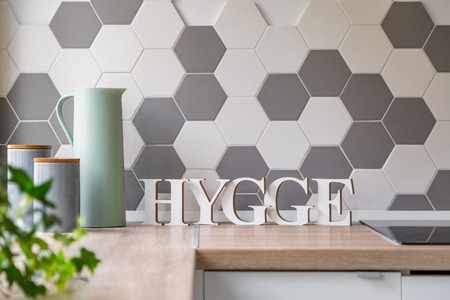 Modern kitchen interior in scandinavian style with wooden countertop and honeycomb wall tilesの写真素材