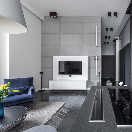 Open cooking area in modern multifunctional apartment with bright living roomの写真素材