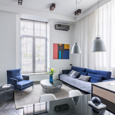Industrial design living room with tv and blue furniture setの写真素材