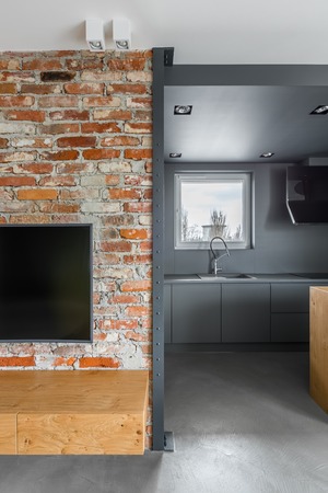 Brick wall with entrance to the kitchen in loft apartmentの写真素材