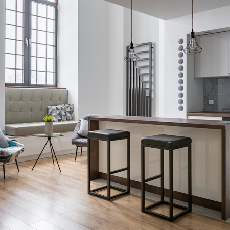 Interior with kitchen island, bar stools and modern lampsの写真素材
