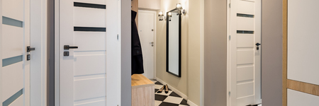 Modern corridor in home interior with white doors, panoramaの写真素材