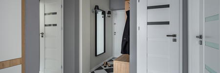 New home interior with white doors and grey walls, panoramaの写真素材