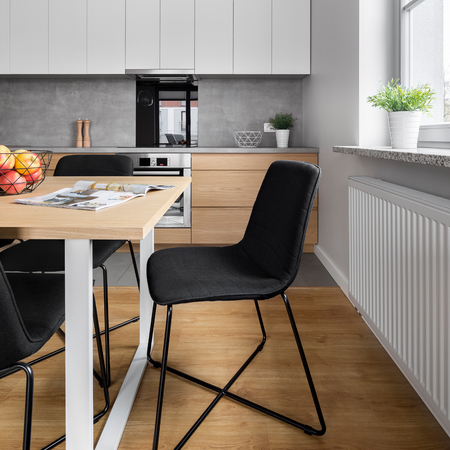 Stylish chairs and table at dining space in the kitchenの写真素材