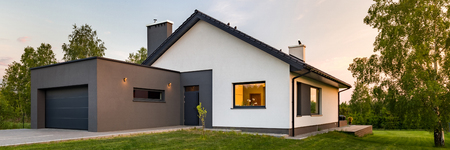 Panorama of a stylish house with large lawn and garage, outdoorsの写真素材
