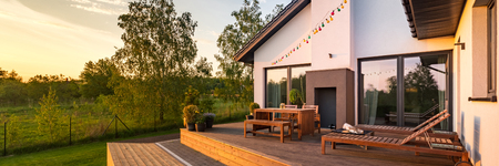 Modern house with patio and functional outdoor furniture, panoramaの写真素材