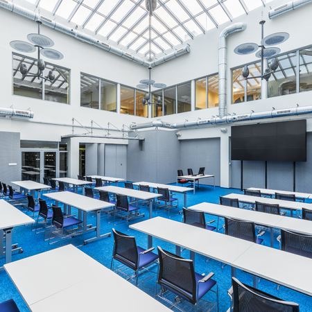 Modern and stylish university lecture hall in grey and blue with glass ceilingの写真素材