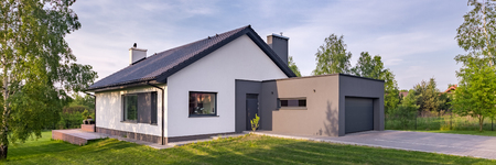 Panoramic view of modern one-story house with garage and sliding roofの写真素材