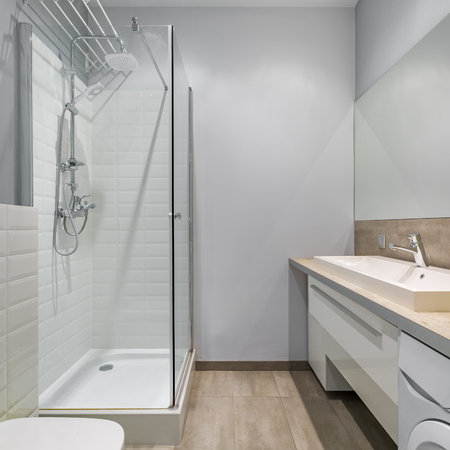 Modern bathroom with shower, countertop basin and big mirrorの写真素材