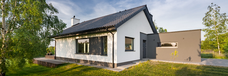 Panoramic view of modern family house with garden in the suburbsの写真素材