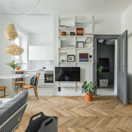 Hygge home interior with wooden floor, tv and bookcaseの写真素材