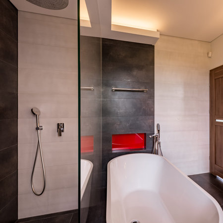 Square frame of modern bathroom with bathtub, shower and red shelf