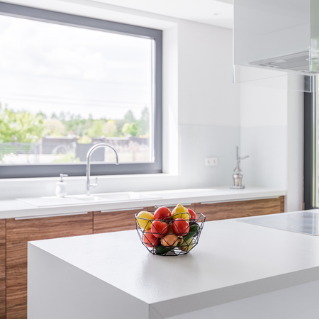 Square frame of stylish, white kitchen with modern island and windowの写真素材