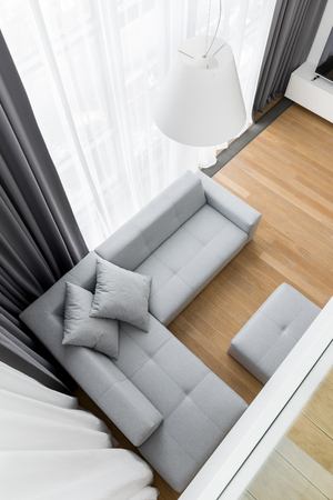 Top view of minimalist living room with gray corner sofaの写真素材