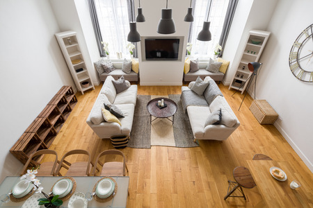 Mountain style living room with wood parquet, two sofas and dining tableの写真素材