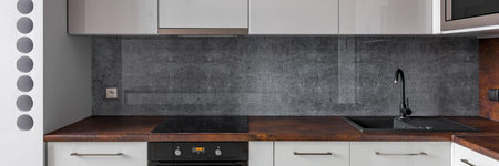 Panorama of new kitchen with granite backsplash and functional cabinets