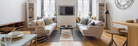 Panorama of modern living room with tv and two sofas