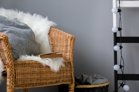 Home leisure area with wicker chair and decorative light chainの写真素材