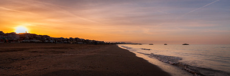 Panorama of amazing sunset over wide beach and adriatic sea in Italyの写真素材