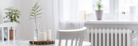 Simple wooden, white and small round table with stylish decoration, panoramaの写真素材