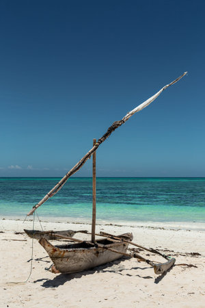Traditional african dhow boat on amazing beach of Zanzibar at azur Indian Ocean