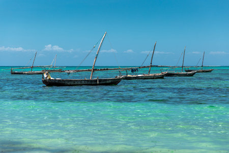 Old wooden fisher boats on turquoise ocean, Zanzibar island