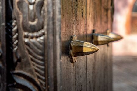 Close-up on old, traditional, wooden door with ornaments from Zanzibarの写真素材