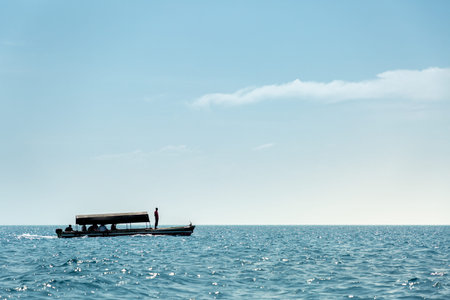 One tourist boat on calm blue water of Indian Ocean