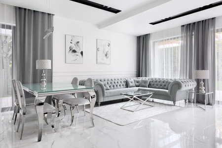 Charming and luxury living room in gray and white with glass table and glamour style corner sofaの写真素材